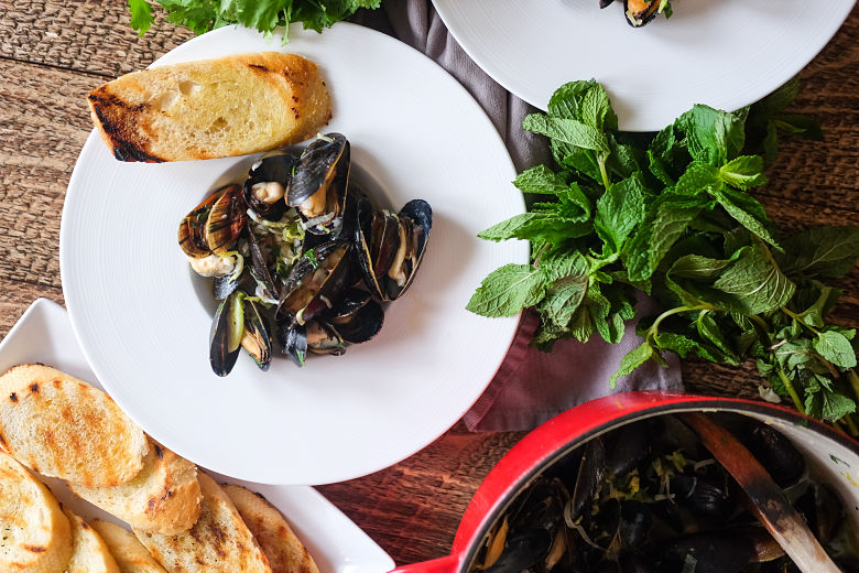 Plump, steamed mussels simmered in a creamy, spicy, citrusy coconut sauce.